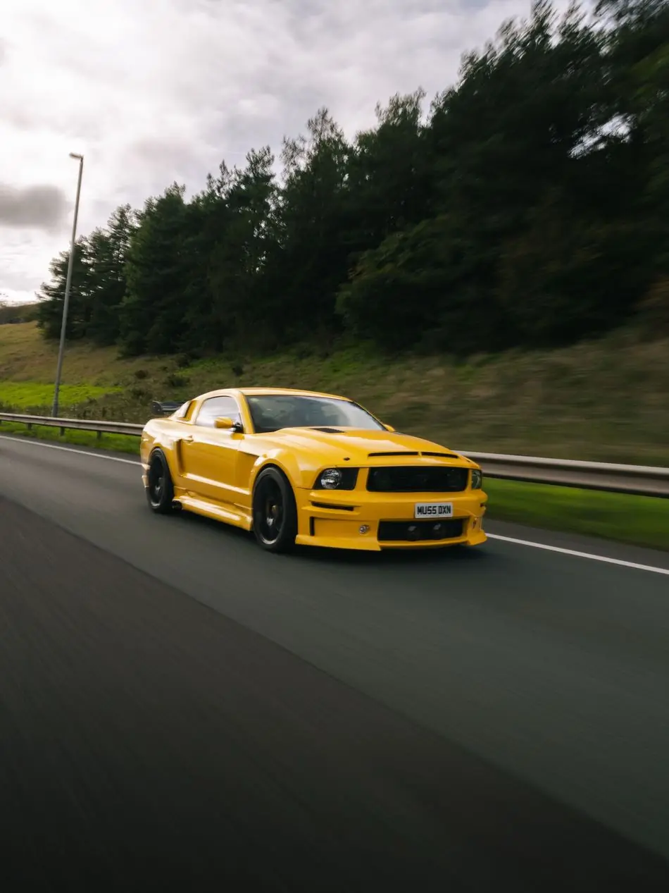 Yellow Ford Mustang on the road